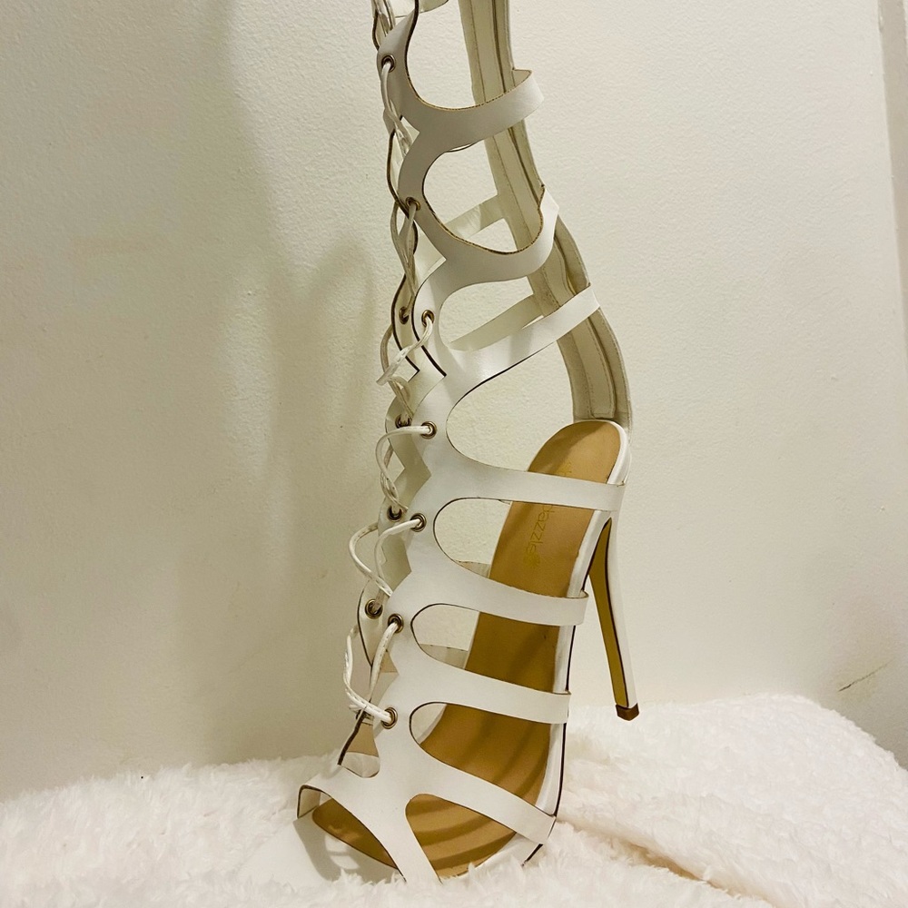White stiletto cage sandal with lace-up styling, and Zipper in the back.